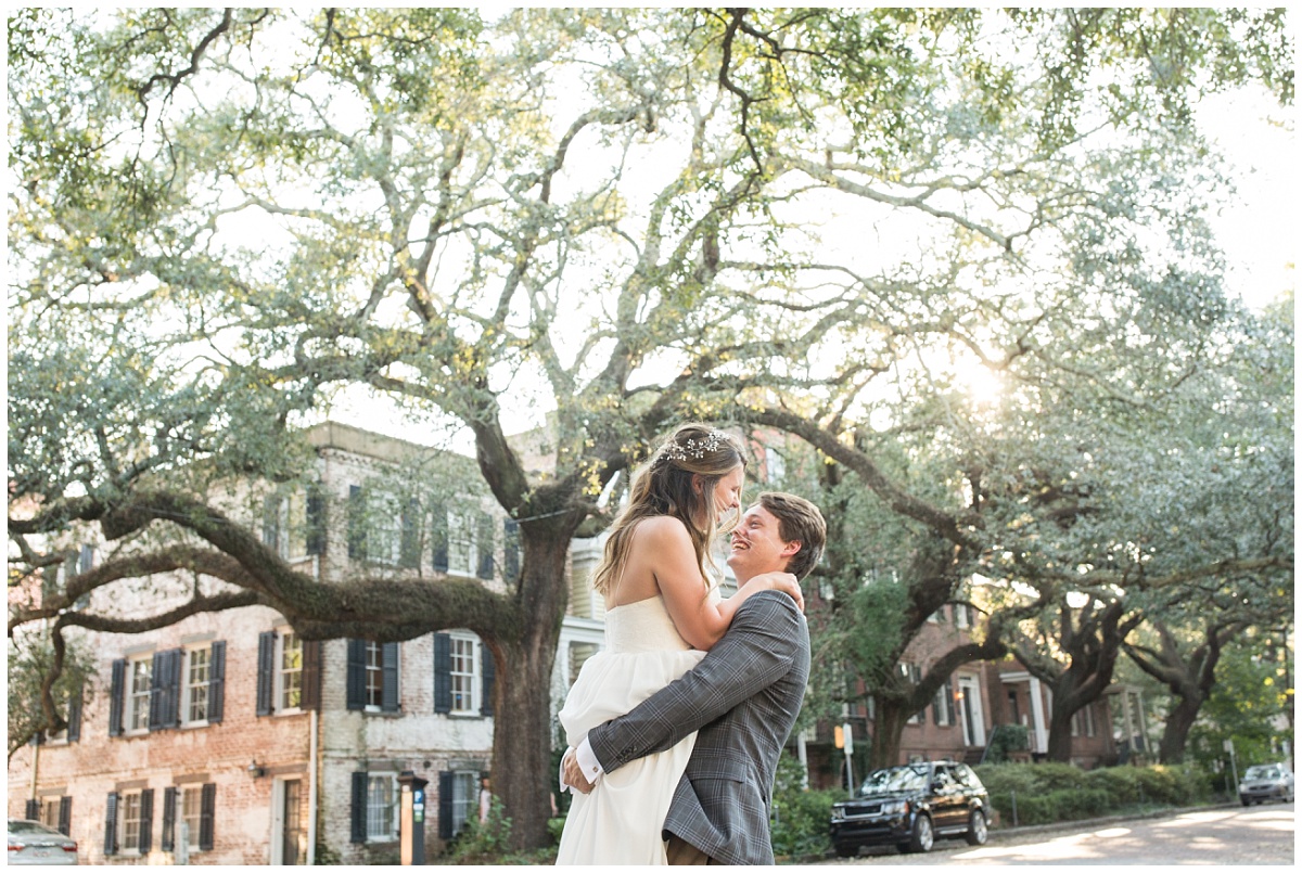 bride and groom kissing with huge oak in background