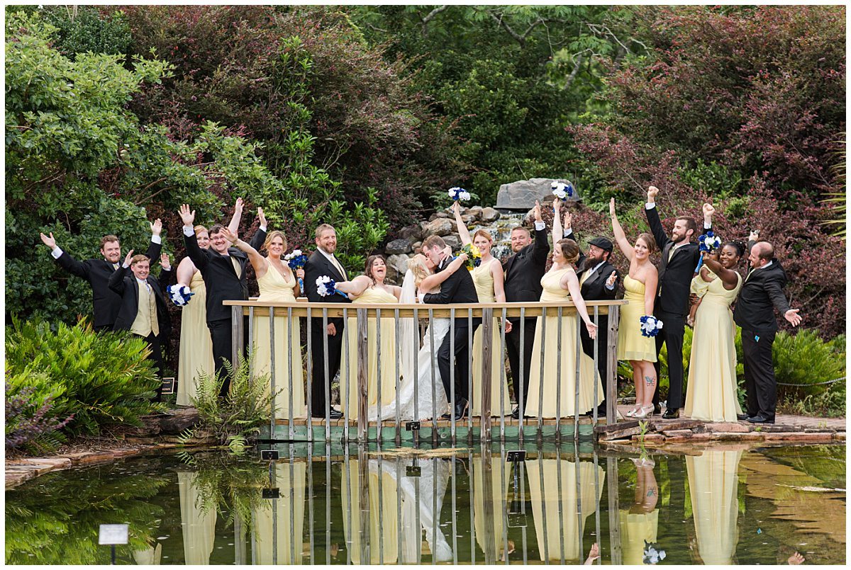 bridal party in from of waterfall gardens at botanical gardens in savannah